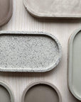 Concrete trinket trays in a range of colors and textures.