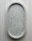 Concrete trinket tray in neutral tone with natural stone texture.