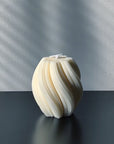 Nev sculptural candle with ribbed swirl textural design.